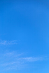 Naklejka na ściany i meble Vetical image a white clouds in blue sky for background