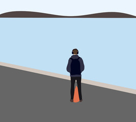Obraz premium Man with headphone listens to music standing near river. Relaxation and resting concept