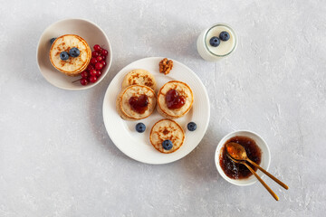 Yogurt and mini pancakes decorated with heart shape jam