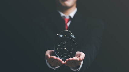 clock on businessman hand, time management concept,effective business planning,time management in...