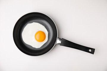 Tasty fried egg in pan on white background, top view