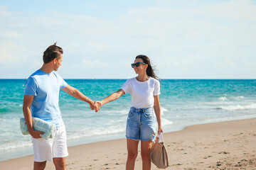 Young couple in love on the beach summer vacation. Happy man and woman enjoy time together