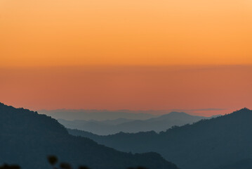 Sunset mountain range beautiful landscape mist, dusk golden time dramatic sky. Beautiful landscape high mountain ridge mist panning panorama scenery dawn dramatic sky. Sunrise landscape mountain peak.