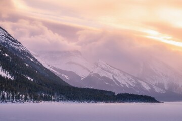 Fototapeta na wymiar Sunrise Clouds Glowing Over Snowy Mountains