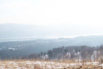 Winter landscape. View of snow-covered hills covered with forest