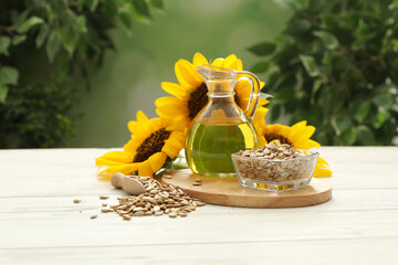 Composition with sunflower oil on white wooden table against blurred background