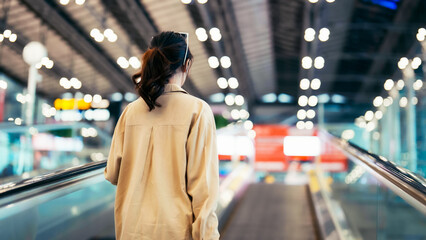 Young asian woman passenger in airport terminal or modern train station. Asia woman commuter...