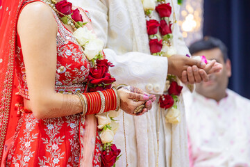 Obraz na płótnie Canvas Indian Hindu wedding ceremony rituals bride and groom's hands close up