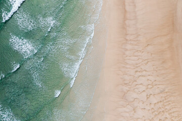 Fototapeta na wymiar Aerial view of stunning waves crushing near sand banks in a stunning blue water