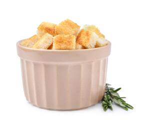 Delicious crispy croutons in bowl and rosemary on white background