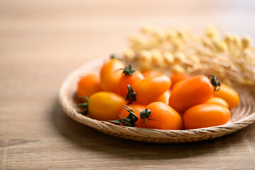 Orange cherry tomatoes in basket, fresh organic vegetable