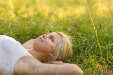 Naklejka na ściany i meble calm smiling woman resting in the park