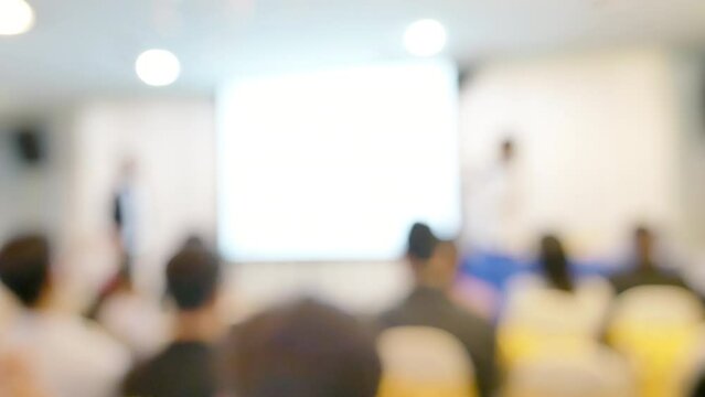 Blur background seminar business event in auditorium  hall convention audience presentation meeting at conference room present screen for entrepreneurs startup business. Blurred background copy space