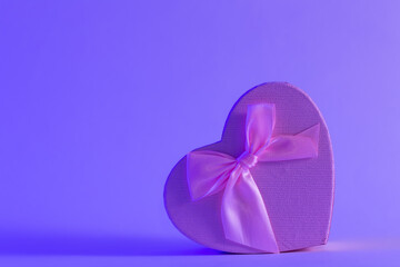 Gift box in the shape of a heart in neon lighting, the concept of Valentine's day, romance and love, copy space.