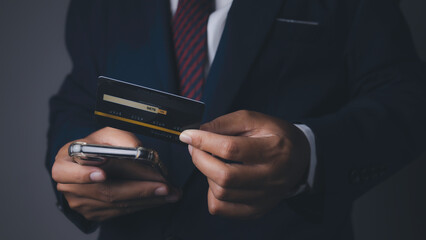 Businessman using mobile phone and credit card shopping online.