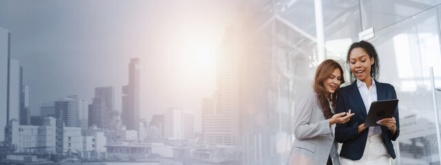 Two asia business women in conversation walking together on city street. Corporate colleagues workmate discussing new project while going to work. business outdoor.