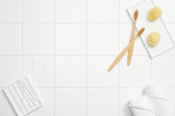 various bathroom objects on white tile, modern mood, top view and copy space