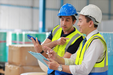 Group of technician engineer and businessman in protective uniform standing and discussing, researching, brainstorming and planning work together with tablet at industry manufacturing factory