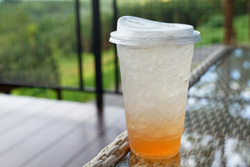 Glass of yuzu soda on a table background. Drink menu in the coffee shop. Soft and selective focus.               