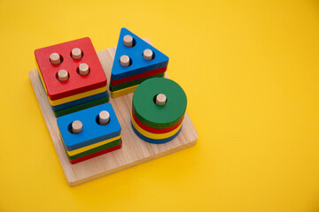 Kid education toys , puzzle toys on yellow background