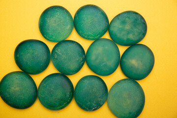 Pattern with close up pebble sea stones on yellow .