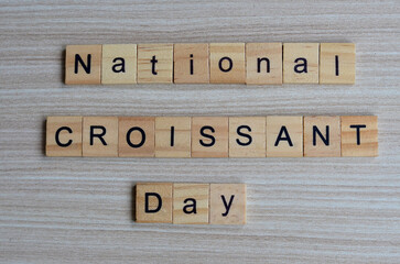 National Croissant day text on wooden square, holiday quotes