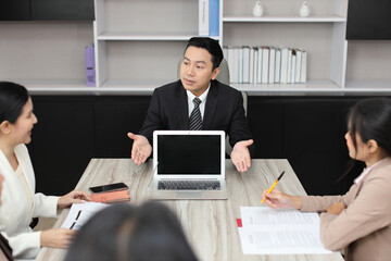 Collaborative process of professional businesspeople going over on new project together, using computer presentation and brainstorming ideas, coworker and working together at office meeting concept