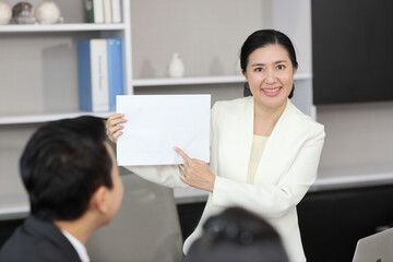 Collaborative process of professional businesspeople going over on new project, using paperwork and computer presentation with brainstorming ideas, coworker and work together at office meeting concept
