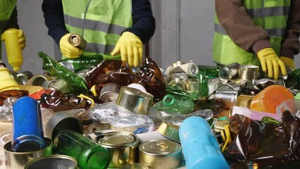 Recycling Sorting Center. Waste sorting belt. Hand separation of waste and the recovery of recyclable materials