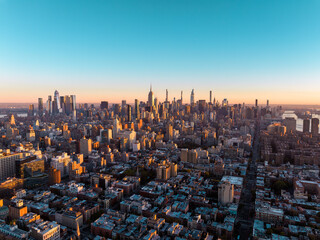 New York City skyline panorama at sunrise. Midtown Manhattan building on horizon, clear sky, copy space