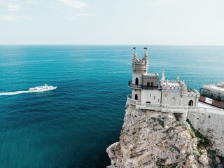 Crimea Swallow's Nest Castle on the rock over the Black Sea. It is a tourist attraction of Crimea. Amazing aerial view of the Crimea coast with the castle above abyss on sunny day.
