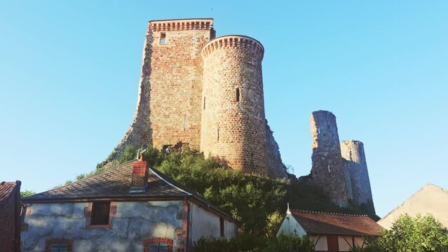 Ruins of Herisson fortress of the Dukes of Bourbon dominate the medieval city of Herisson and Aumance Valley with towers standing tall in the inner castle in central France. High quality 4k footage