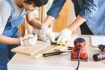 Southeast asian family father and son diy or repair for crafts skill at home workshop