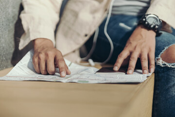 Tourists point their fingers at the map to find attractions, restaurants or hotels..backpacker and travel concept.
