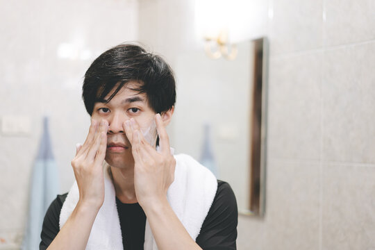 Alone Adult Asian Man Looking At Mirror Skincare Routine.