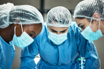 Healthcare, teamwork and surgery, doctors in operating room in medical emergency at hospital. Doctor, nurses and diversity, surgical team in operation theater together with ppe, face mask and scrubs.