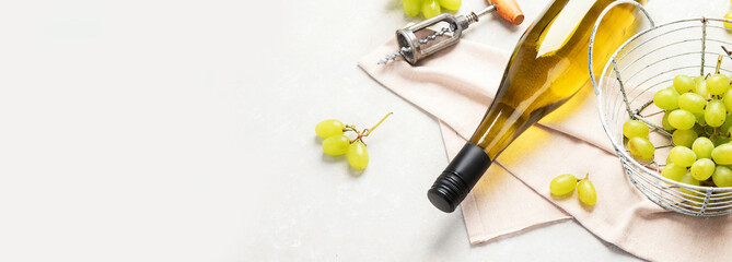 Fototapeta na wymiar Glasses and bottle with white wine on a white background.