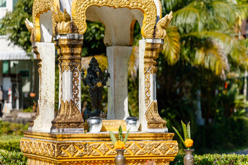 Selective focus of white-golden spirit house in Thailand
