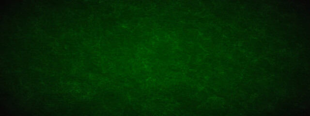 Dark green background with grunge backdrop texture, watercolor painted mottled green background, colorful bright ink and watercolor textures on black paper background. 