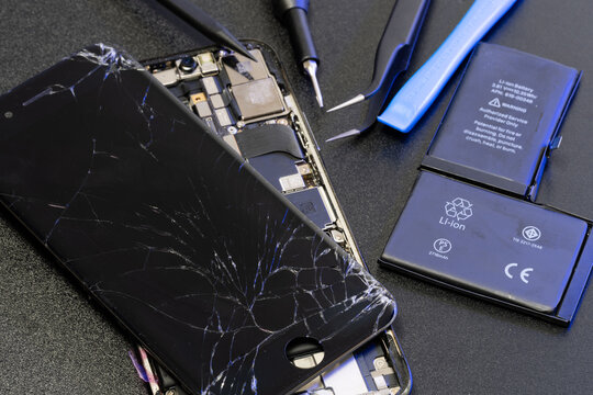 Broken iPhone display on top of new iPhone model. Replacement parts for Smartphone