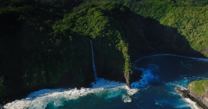 Aerial view of Maui Hawaii tropical waterfall ocean coastline 
