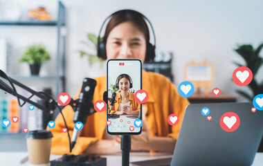 Vlogger live streaming podcast review on social media, Young Asian woman use microphones wear headphones with laptop record video. Content creator concept. - obrazy, fototapety, plakaty
