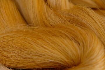 Raw, unprocessed silk yarn from yellow cocoons of the silk worm.