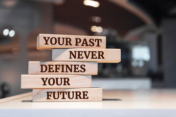 Wooden blocks with words 'Your Past Never Defines Your Future'.
