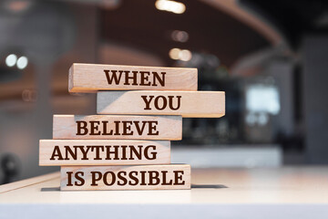 Wooden blocks with words 'When You Believe Anything Is Possible'.