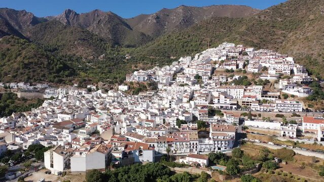 Scenic aerial view of small Andalusian township of Ojen located in mountain valley in foothills of Sierra Blanca and Sierra Alpujata ranges on sunny autumn, Spain