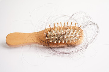 Hair loss fall with comb brush isolated on white background.