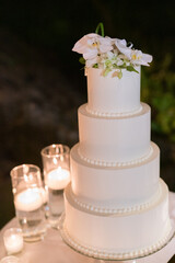 Obraz na płótnie Canvas Three tiered wedding cake on a table