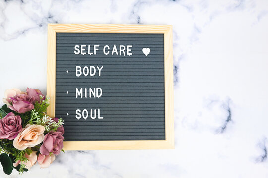 Letter board with phrase Self care, body, mind, soul with heart. Concept of mental health, mindfulness, self love. Aspiration, supportive sentence, law of attractions, affirmatives, subconscious mind