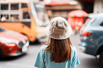 Young Woman with hat traveling in Bangkok, Asian traveler visiting at Yaowarat road or Chinatown of Bangkok, landmark and popular for tourist attractions in Thailand. Southeast Asia Travel concept